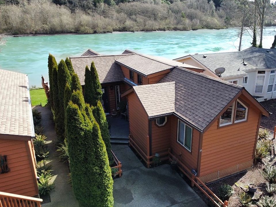 Aerial view of a cedar home on the riverfront