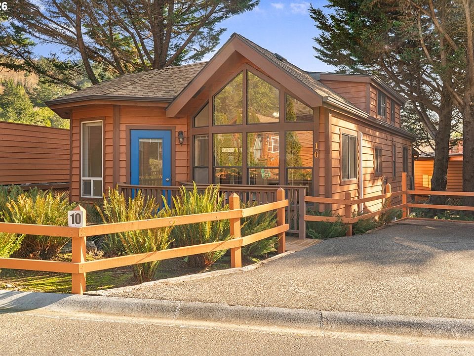 New cedar home with a covered front porch and landscaped entry